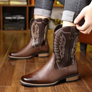 Close-up of brown Western cowboy boots with intricate embroidery and V-neck design.