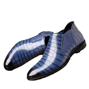 Close-up of men's blue crocodile embossed leather Chelsea boots for business casual wear