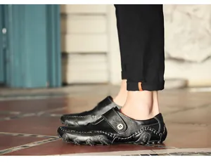 Detailed side view of black leather loafers with distinctive octopus rubber outsole