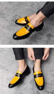 Detail shot of men's trendy color-blocked slip-on loafers in black and yellow.