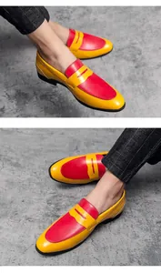 Detail shot of men's vibrant red and yellow color-block leather loafers on model