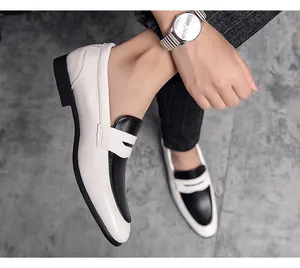 Close-up of stylish black and white contrast men's business loafers in a modern office look