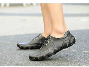 Detailed side view of men's black leather casual driving shoes with unique octopus sole design
