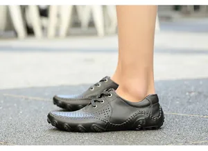 Close-up of men's black leather octopus loafers worn outdoors for a casual look