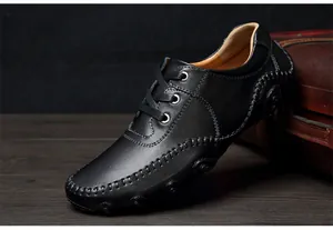 Detailed side view of black leather driving shoes with unique octopus sole design.