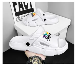 Close-up of white outdoor sports clogs with colorful graffiti print and black strap.