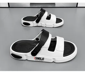 Vista laterale dettagliata dei sandali sportivi bianchi e neri con il logo SMILE