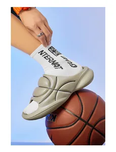 Detail view of khaki sports slides featuring basketball texture and thick cushioned sole