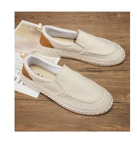 Men's breathable cream linen slip-on espadrille shoes with brown accents on wooden background