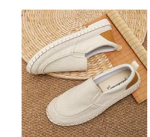 Close-up of beige men's breathable linen loafers with hand-stitched sole detail