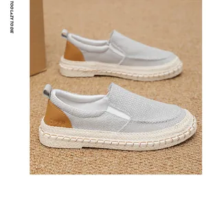 Detailed view of men's breathable grey canvas slip-on loafers with textured soles