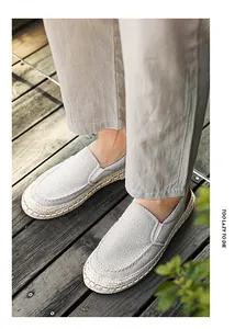 Detailed view of breathable men's grey linen loafers in a casual outdoor setting