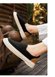 Close-up detail of men's breathable black linen slip-on loafers with woven texture sole
