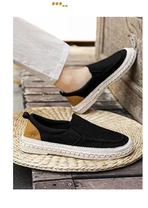 Detailed look at breathable black men's loafers with woven soles and brown heel accents