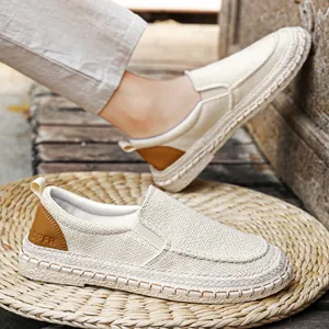 Men's breathable beige linen slip-on loafers with brown heel detail on straw mat