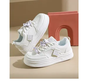Trendy white platform sneakers for women featuring cute lavender cartoon charms on laces.