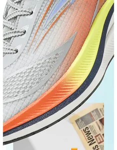 Close-up detail of mesh upper and gradient sole on breathable running shoes