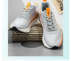 Detailed view of grey and orange breathable mesh running shoes for men's outdoor