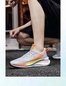 Side view of lightweight breathable gray men's mesh running sneakers with orange accents.