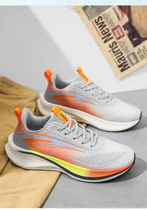 Detail of breathable mesh running shoes with cushioned thick soles and orange accents.