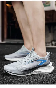 Detailed side view of breathable mesh men's running sneakers in grey and blue