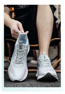 Detail view of breathable grey mesh running shoes for men in a lifestyle setting