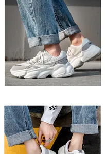 Close-up of white and grey breathable chunky dad sneakers with thick soles.