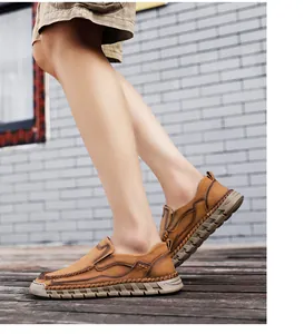 Close-up of men's vintage brown slip-on leather shoes on wooden deck