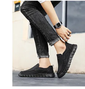 Side view detail of men's black retro casual leather slip-on shoes with hand-stitched sole