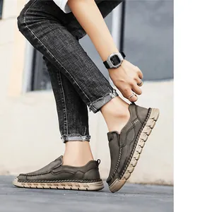 Detailed side action shot of model wearing retro casual men's slip-on leather shoes outdoors