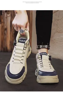 Close-up of high-top work boots with rotary buckle and durable rubber sole.