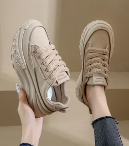 Detail view of beige platform chunky sneakers with woven laces and thick wavy sole