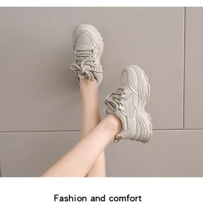 Stylish beige chunky platform sneakers for women shown on feet in a studio setting