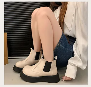 Chic beige platform Chelsea boots for women styled with casual wear on a model.
