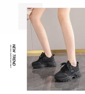 Detailed side view of trendy women's black chunky sneakers worn by an Asian model