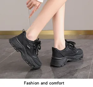 Close-up side view of stylish black platform sneakers for women with a thick sole