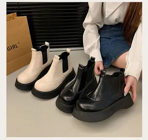 Detailed view of women's platform Martin boots in black and cream beige leather