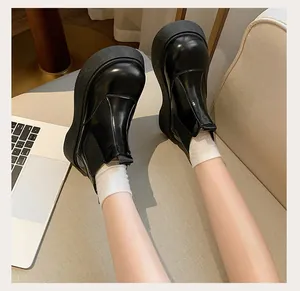 Detail view of women's black platform Martin boots with retro round toe and thick sole.