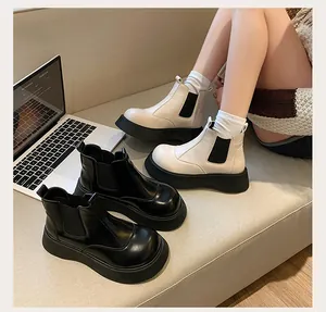 Stylish platform Chelsea boots for women in black and beige lifestyle scene shot