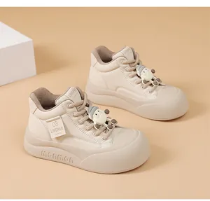 Close-up detail of cream beige platform bread sneakers with cute sheep charms on laces