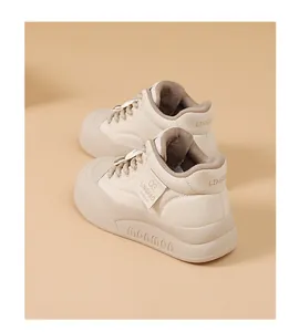 Detail view of beige chunky bread sneakers with thick soles and plush warm lining.