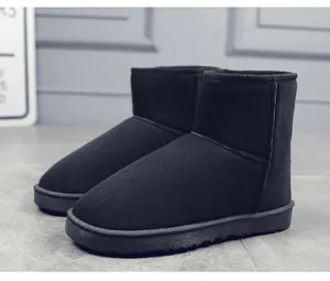 Close-up view of classic black suede snow boots with a thick anti-slip sole for winter