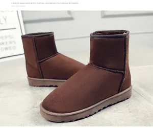 Close-up of warm brown suede snow boots with thick fleece lining and durable soles