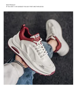 Close-up detail of retro chunky sneakers with white and red color-blocked design.