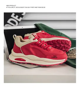 Red and beige chunky retro dad shoes displayed in a stylish urban lifestyle setting.