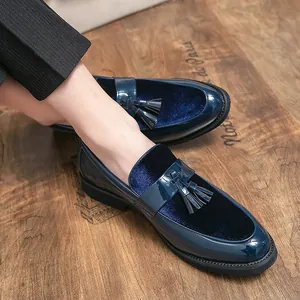 Elegant navy blue velvet and patent leather tassel loafers for men on wooden floor