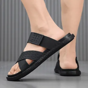 Close-up of black breathable men's beach sandals with non-slip sole and textured straps