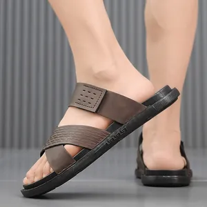 Close-up of men's casual brown cross-strap sandals with durable textured soles.