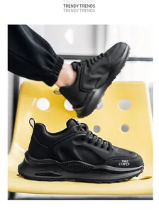 Detailed view of black men's thick-soled retro dad sneakers on a yellow chair