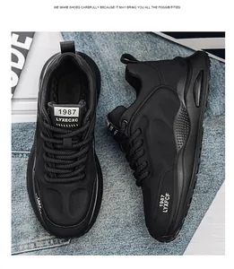 Detailed view of black chunky retro sneakers with 1987 text on denim background.